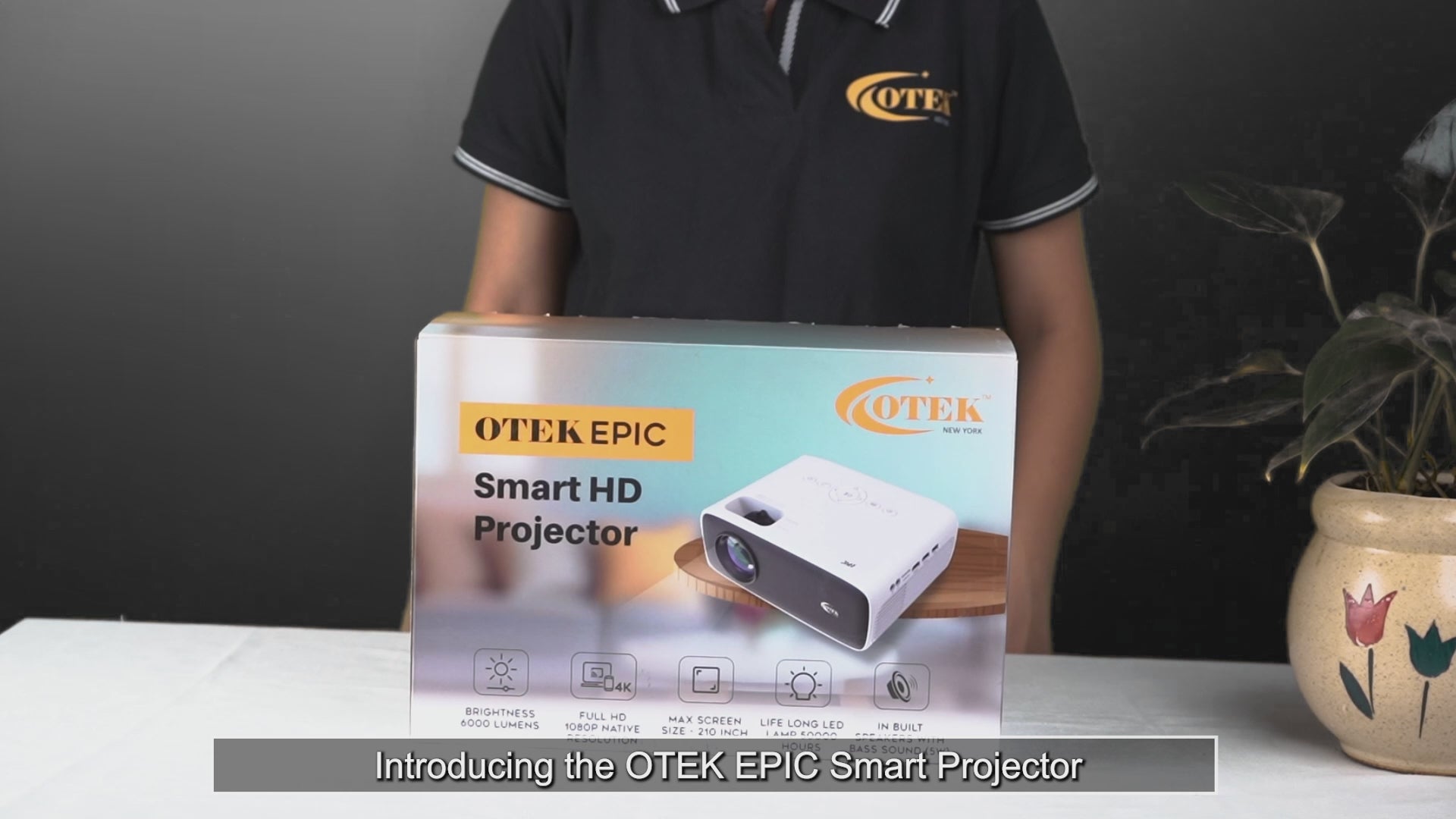 Load video: OTEKWORLD EPIC Projector casting bright, cinematic visuals on a large screen in a home theater setup