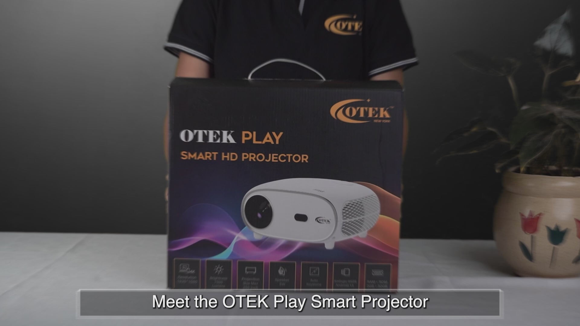 Load video: OTEKWORLD home theater projector displaying vibrant HD visuals on a wall screen in a dark room